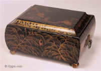 Delightful Regency fitted sewing box decorated with erudite Chinoiserie images  opening to a  compartmentalized lift out tray .  The  artist who painted the box seems to have an understanding of the symbolism and  style of Chinese Export lacquer. On the  convex sides are depictions of feathery willows. The raised painting on the top depicts figures in a garden. The  box has embossed gilded pressed brass drop ring handles and ball feet.  These are typical of the Regency , Circa 1815. Enlarge Picture