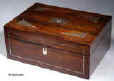 SB127:  A rosewood veneered box of rectangular form, inlaid with mother of pearl and white metal in  a stylized pattern, which forms a fine foliated design in reverse, the box having a lift out tray, still covered with its original blue paper  with divisions  for sewing. Circa 1830. Enlarge Picture