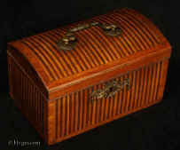 TC537: 18th century tea caddy with domed top  the oak carcass veneered with a parquetry of rosewood and satinwood  in alternating stripes. framed by a crossbanding in kingwood.  The escutcheon is gilded bronze.  The inside is lined with lead foil. There is a single lid which would sit on the tea in the 18th century manner. Circa 1770. Enlarge Picture