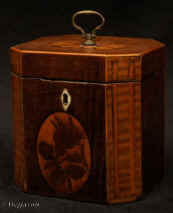 TC551:  A  fine one compartment inlaid George III Tea Caddy circa 1790  of octagonal form veneered in various woods including stained maple (harewood).  The hinged top and large sides  inlaid with marquetry medallions.  The front cartouche depicts a rose in bud. the top a patera  executed using the hot sand method.   The canted corners have blind flute inlay. Enlarge Picture