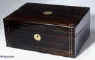 WB172: A coromandel writing box, the front and top inlaid with brass, the sides and back ebonized, opening to a fitted interior with embossed leather writing surface, and compartments for paper and writing instruments, Circa 1860.  Enlarge Picture