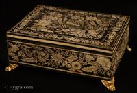 JB706: Penwork decorated  box made in gessoed beech and standing on embossed gilded brass feet. This particular box is very reminiscent of Anglo Indian work, both in the contrast of black on white which resembles ivory incised decoration. The patterns of plants and flowers are executed in the manner of fabric and embroidery design, which was fashionable in penwork of the period. However the top design goes further than most such work, in that the peacock is central to an asymmetrical tree of life motif which is characteristic of 18th century Indian inlaid work. Exceptionally well designed and executed.  Circa 1790.