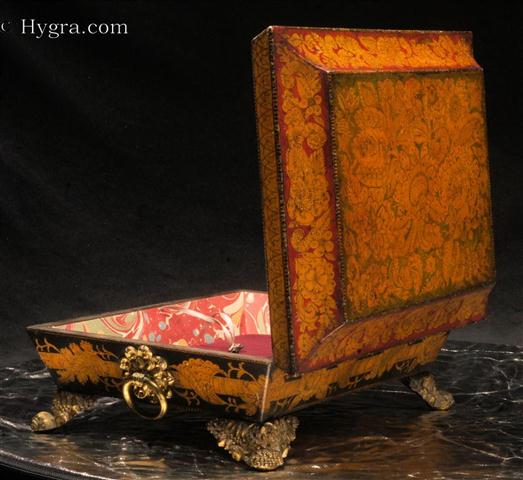 A rare Regency polychrome penwork box with tapering  sides and pyramid top standing on gilded embossed feet. The  colors are particularly rare. The  decorated in penwork,  depicts stylized representations of fantastical flowers and leaves. The penwork is within the tradition of fabric design which was popular during the 18th century. Such designs drew their inspiration both from eastern work and from European 16th and 17th century embroidery designs.  Enlarge Picture