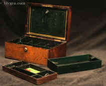 A very finely figured rosewood box with  brass inlay by D Edwards, with working Bramah lock. The inside is compartmentalized and lined in silk and leather. The box has two  lift out trays with velvet and leather linings. There are two additional little leather covered drawers at the bottom of the box. The wonderful green silk is original. There is a silk and leather document wallet with  a blotting pad.  The box has a patented by Edwards hinge which is reminiscent of a hinge for snuff boxes invented by James Sandy.   the lift out  blotting pad is embossed with gold lettering "D. EDWARDS - MANUFACTURER TO HER MAJESTY - 21 KING STREET - BLOOMSBURY - LONDON" 