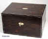 JB306: Antique box veneered with richly  figured coromandel and subtly  inlaid to the top and front with a brass line, and edged with a rounded bead of ebony.  The box opens to a liftout tray which has been relined with velvet. The box also has a sprung side drawer  held in place by a brass pin. The box has   a working lock and key. circa 1850. Enlarge Picture