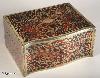  JB315: Boulle box in brass and red tortoiseshell having a serpentine front. and engraved brass and Boulle in red tortoiseshell depicting stylized scrolling  floral motifs to top sides and front.   The box is lined with silk and velvet. Circa 1840.  
