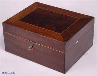   SB114: Antique sewing box veneered with mahogany, the top having a central panel of darker color framed by a mitered border of lighter color and contrasting figure, the inside being fitted for sewing with compartments for thread. Circa 1800.