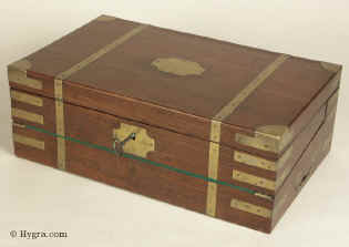 A Georgian Mahogany Triple Opening brass bound Writing Box circa 1815 with original inkwells and secret drawers. The box is in the military style and has countersunk carrying handles made of brass as well as brass corners and straps.